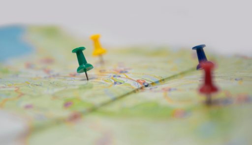 Set,Of,Pushpins,Pinned,On,A,Paper,Map,,Various,Colors,